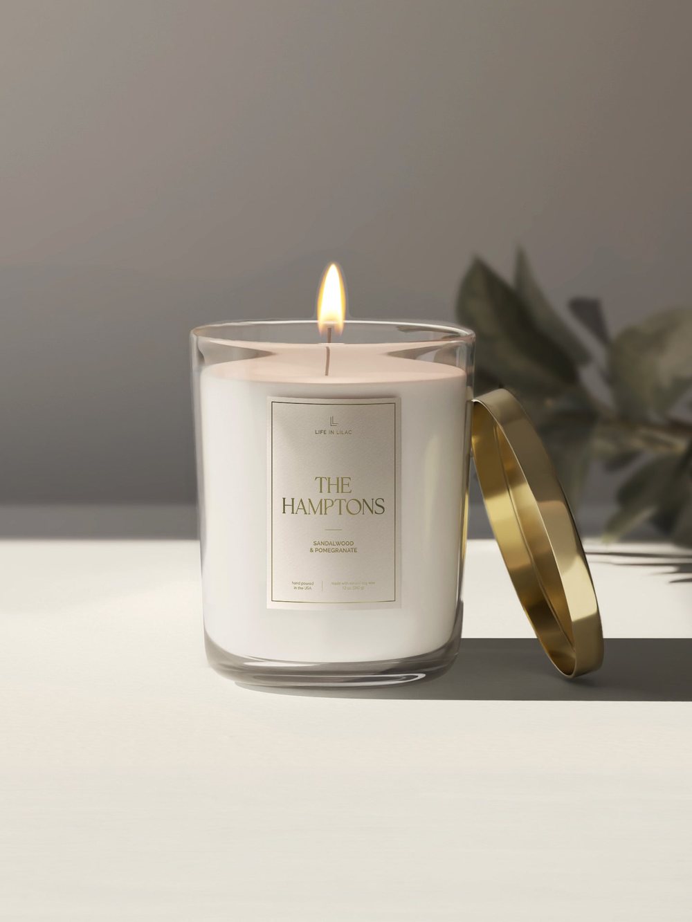 The Hamptons soy candle in a clear jar with gold lid